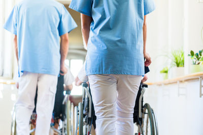 Rear view of people walking in corridor