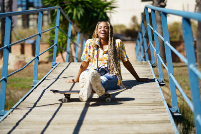 Portrait of young woman sitting on staircase