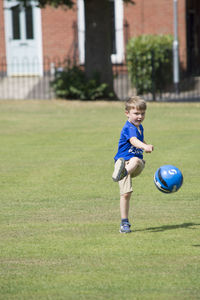 Boy playing soccer at park