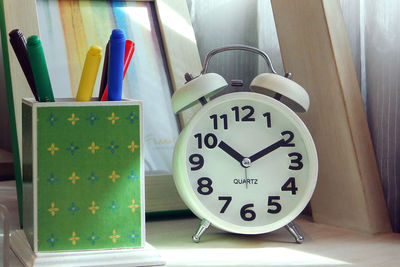 Close-up of clock on table