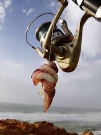 Close-up of clothes hanging on beach against sky