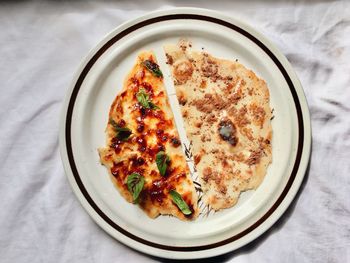 High angle view of pizza served on table