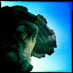 Low angle view of statue against blue sky