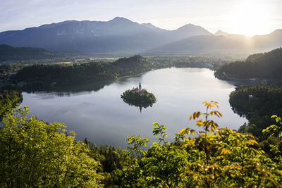 Scenic view of lake and mountains against sky