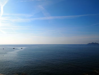 Scenic view of sea against blue sky