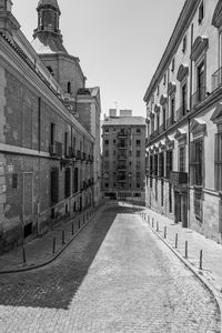 Street amidst buildings in city against clear sky