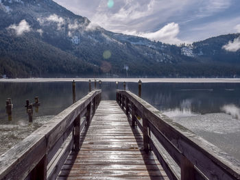 Pier over lake against sky