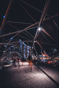 Illuminated bridge over city at night