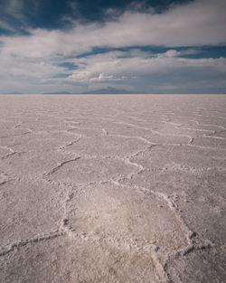 Scenic view of salt flat against sky