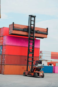 Stack of metallic structure against sky