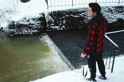 Rear view of man standing in snow