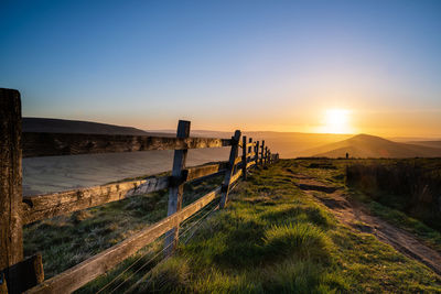Scenic view of field against clear sky during sunset