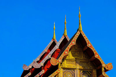 Low angle view of temple against clear blue sky