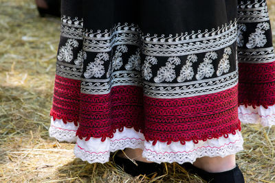 Low section of woman standing on field