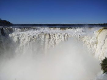 Scenic view of waterfall against clear sky