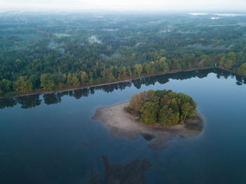 High angle view of lake in forest against sky
