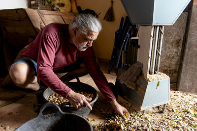 Male farmer checking his almond harvest after doing its harvest