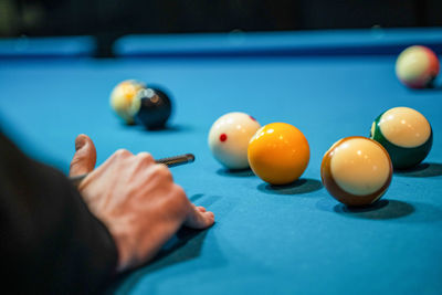 Cropped hand playing pool