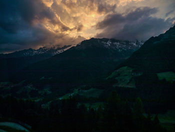 Scenic view of mountains against cloudy sky