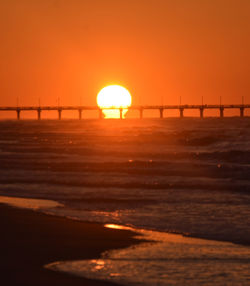 Scenic view of sea against orange sky