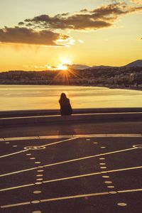 View of man on road at sunset