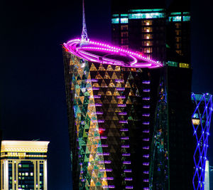 Low angle view of illuminated buildings at night