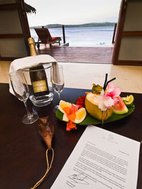 Flower vase on table by sea