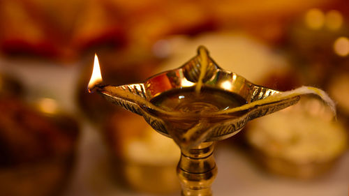 Close-up of lit candles in temple