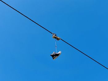 Low angle view of crane against clear blue sky