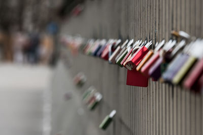 Close-up of locks hanging on railing