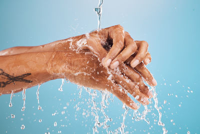 Low section of person washing hands