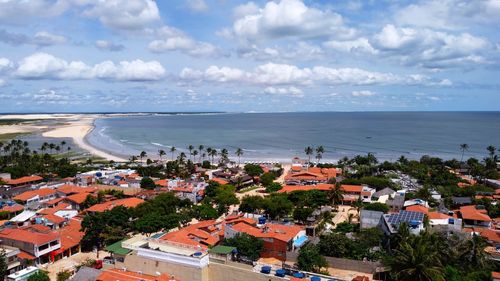 High angle view of townscape by sea against sky