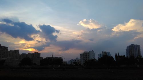 Silhouette buildings against sky during sunset