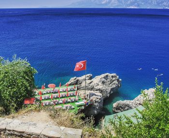 High angle view of turkish flag waving on rock formation