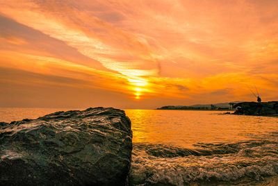 Scenic view of sea against orange sky