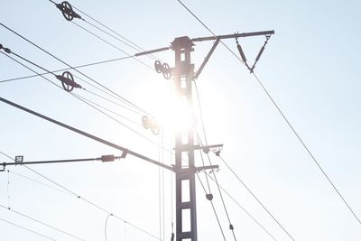 Low angle view of overhead cable car against sky