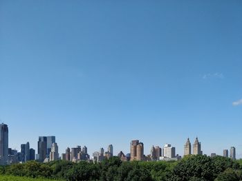 Modern buildings against clear blue sky