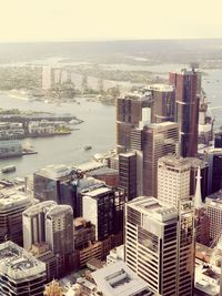 High angle view of buildings by sea against sky