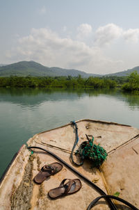 Scenic view of lake and simple plastic raft against sky, sierra leone, africa