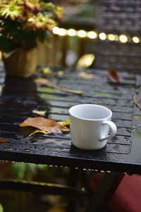 Close-up of coffee cup on wet table