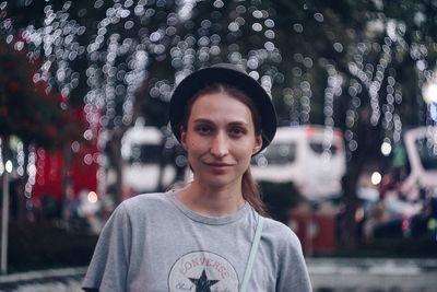 Portrait of smiling young woman in city