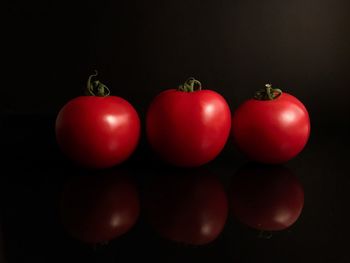 Close-up of tomatoes against black background