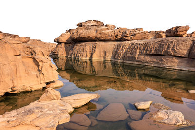 Ancient rocks stone part under the meakong river basin in the dry season cut-out on white 