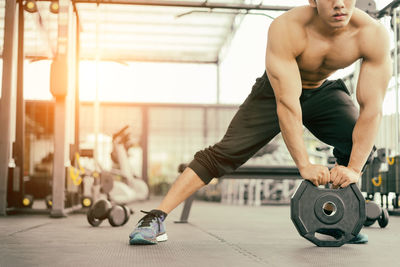 Midsection of holding weights at gym