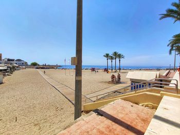 Scenic view of beach against clear blue sky