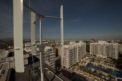 High angle view of street by buildings against sky