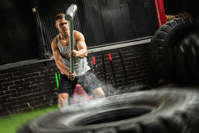 Low angle view of man exercising in gym