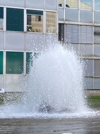 Water splashing on window of building