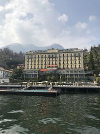 Grand hotel tremezzo by river against sky in city