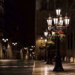 View of illuminated street lights at night